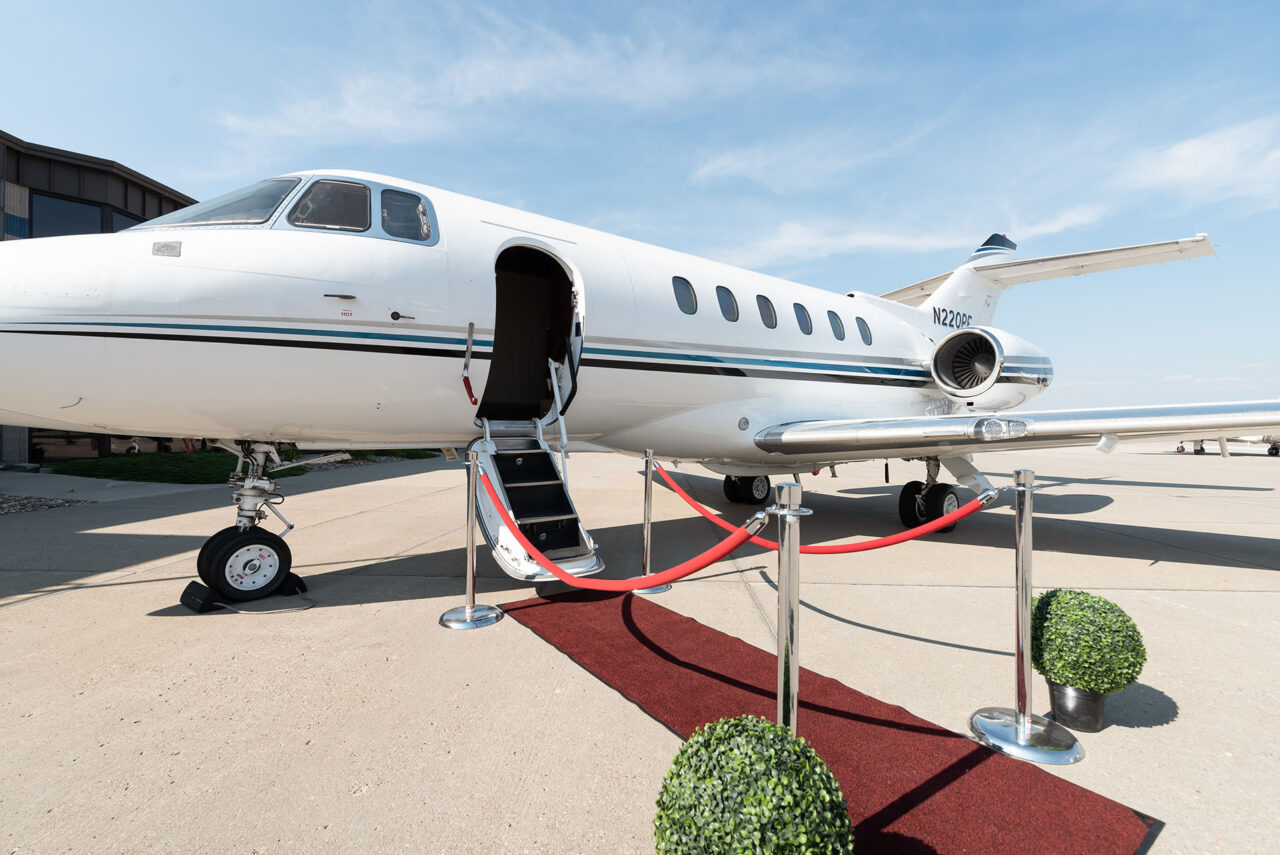Hawker 800XP outside view with open door and red carpet leading to entrance