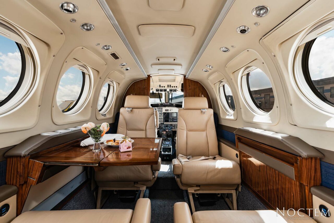 Inside seating in King Air E90 with table set on left side