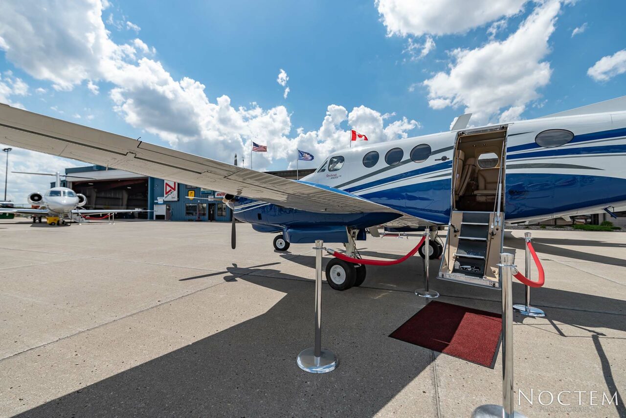 Outside view of King Air E90 with red carpet leading to open door