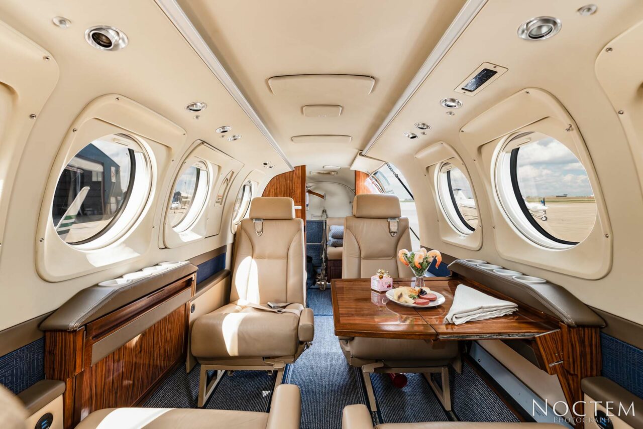 Inside seating in King Air E90 with table set on right side