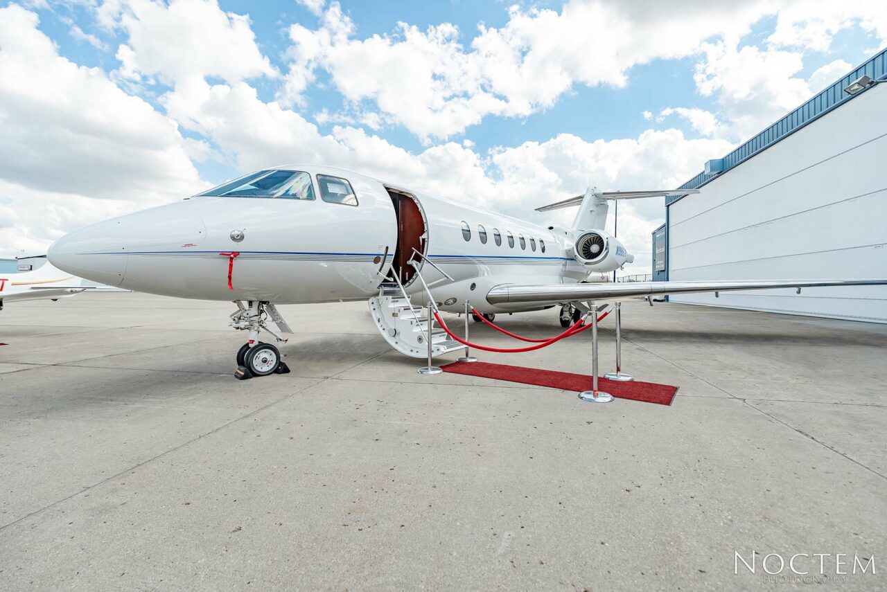 outside side view of Hawker 4000 with red carpet leading to open door
